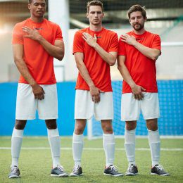 depositphotos 248196544 stock photo three young footballers giving vow